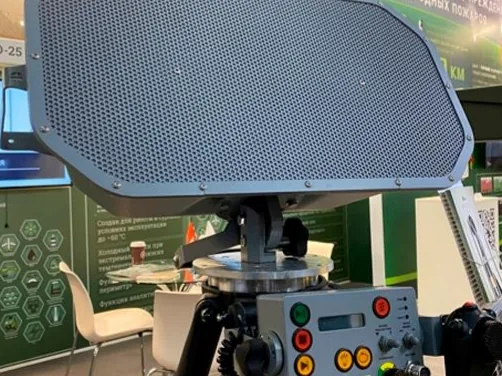 LRAD 450XL, un panel acústico rectangular gris sobre trípode con su unidad de control.